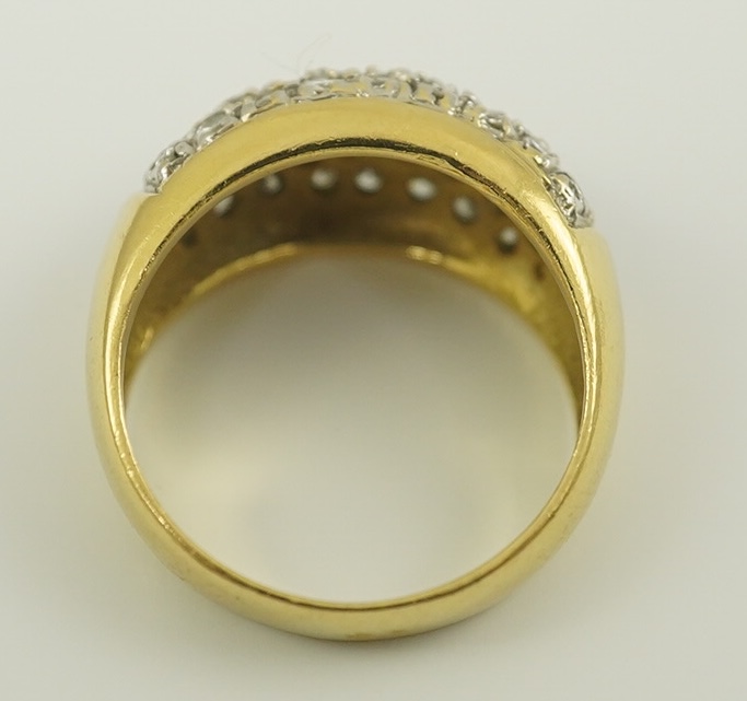 A modern 18k gold and diamond cluster set domed ring